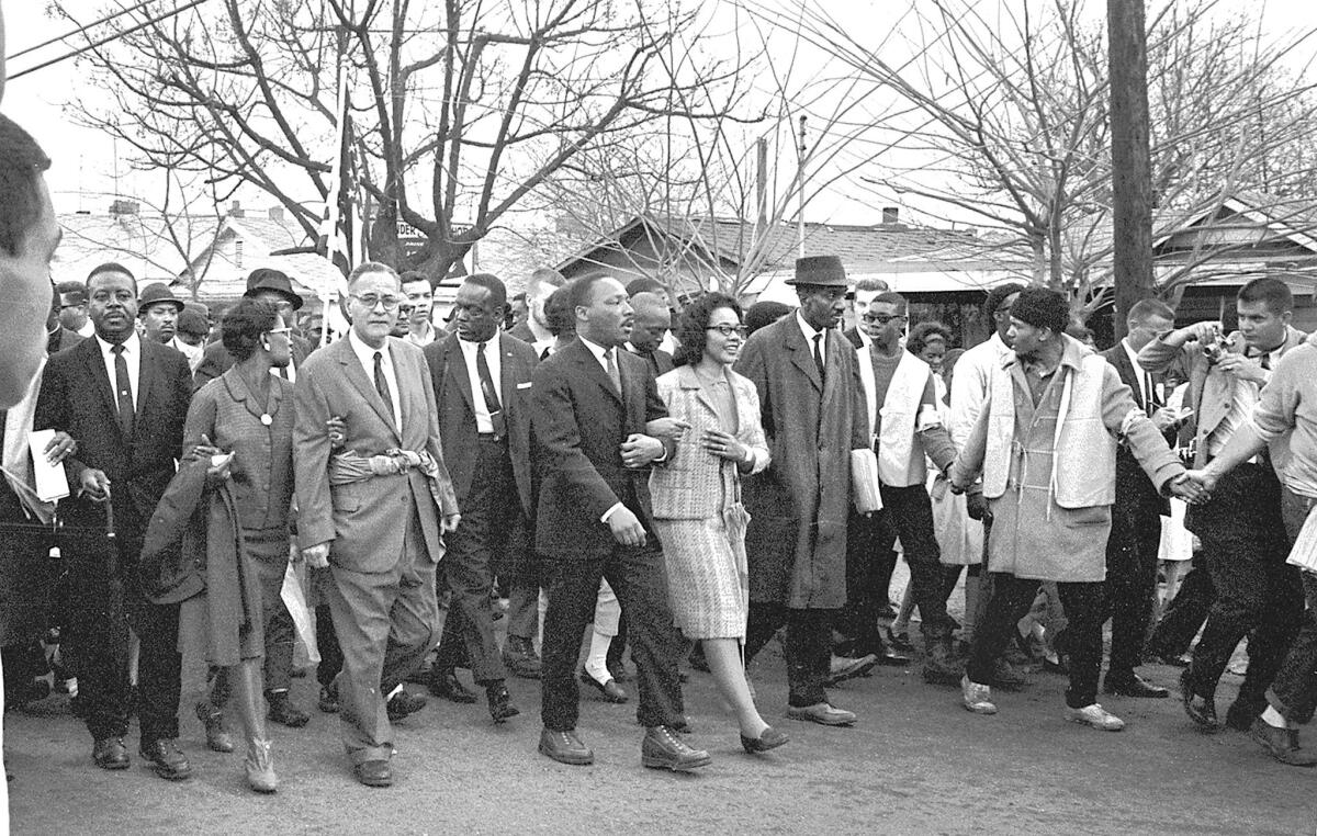 Martin Luther King Jr. and his wife Coretta Scott King lead others on the Selma to Montgomery marches held in support of voting rights in Alabama in March 1965.