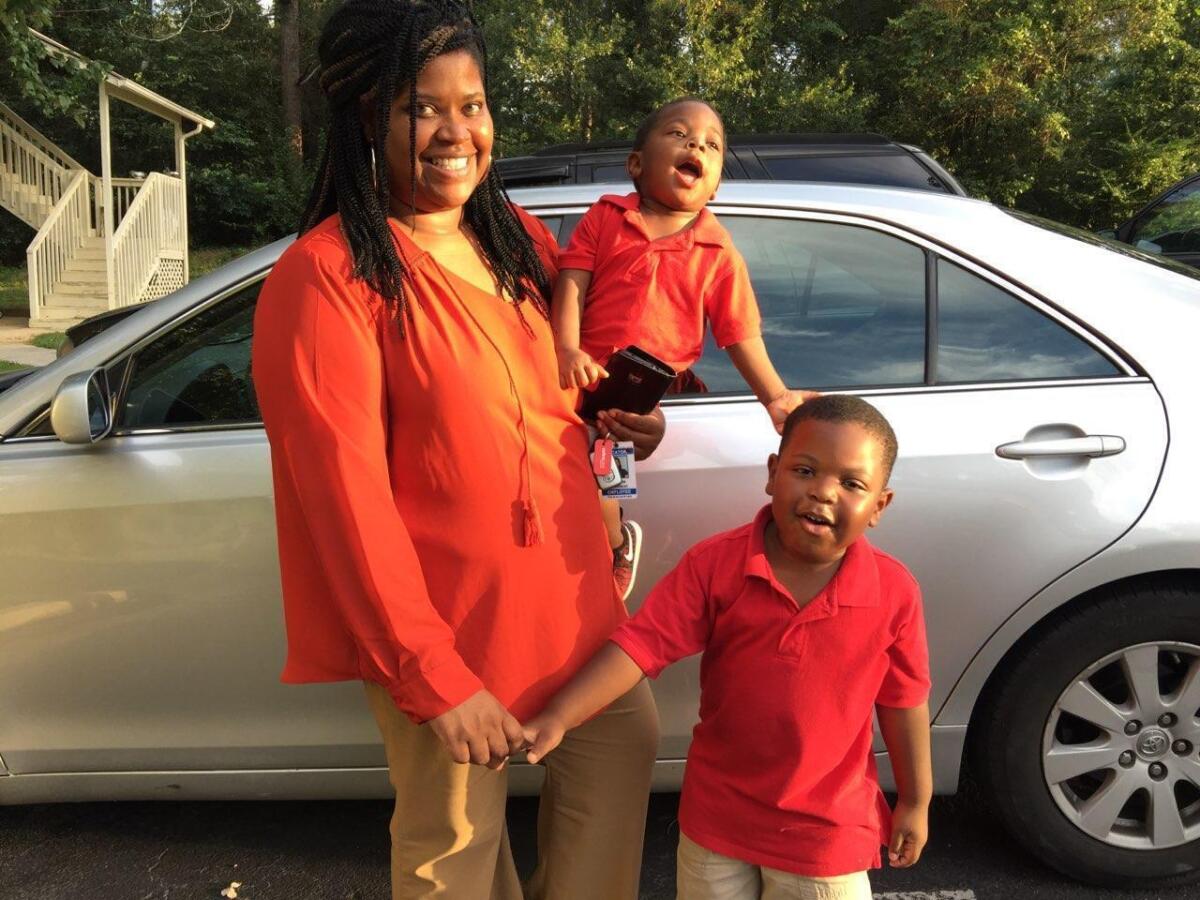 In this 2017 photo provided by her family, Saferia Johnson, of Thomasville, Ga., holds her sons, Kyrei, center, and Josiah. Johnson earned a reputation as a mentor and mother figure to many and time and again, she was a fast friend, who followed a chance encounter with an outflow of kindness that ensured would-be strangers instead lived lives forever intertwined. In August 2020, she died at the age of 36 from COVID-19. (Family photo via AP)