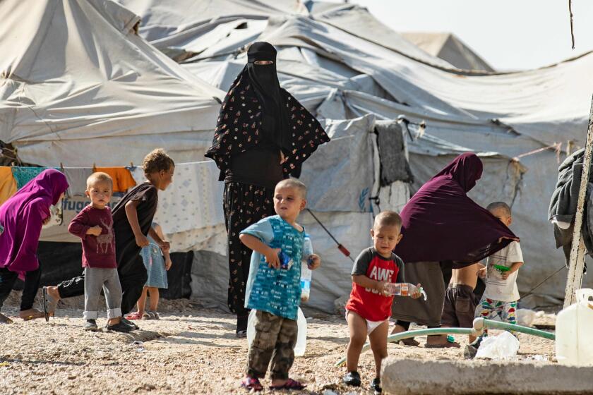 TOPSHOT - Women look after children at the Kurdish-run al-Hol camp for the displaced where families of Islamic State (IS) foreign fighters are held, in the al-Hasakeh governorate in northeastern Syria, on October 17, 2019. (Photo by Delil SOULEIMAN / AFP) (Photo by DELIL SOULEIMAN/AFP via Getty Images) ** OUTS - ELSENT, FPG, CM - OUTS * NM, PH, VA if sourced by CT, LA or MoD **