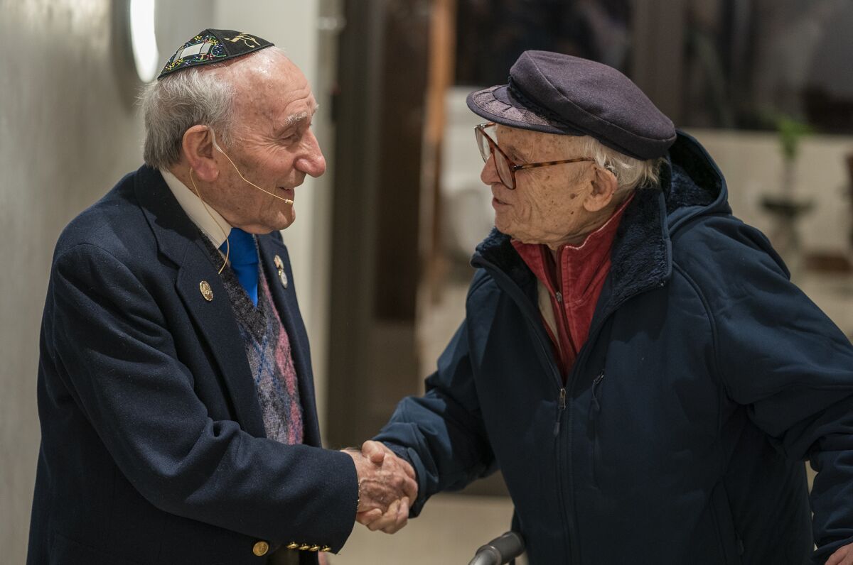 Joseph Alexander, left, speaks with Dr. Jacob Eisenbach. Both are Holocaust survivors.