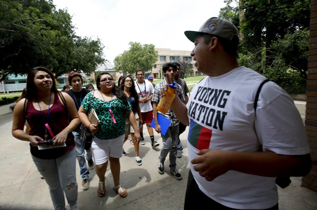 Fifth-year student Nelson Guevara, right, gives a tour of the UC Riverside campus to Native American students in 2013.