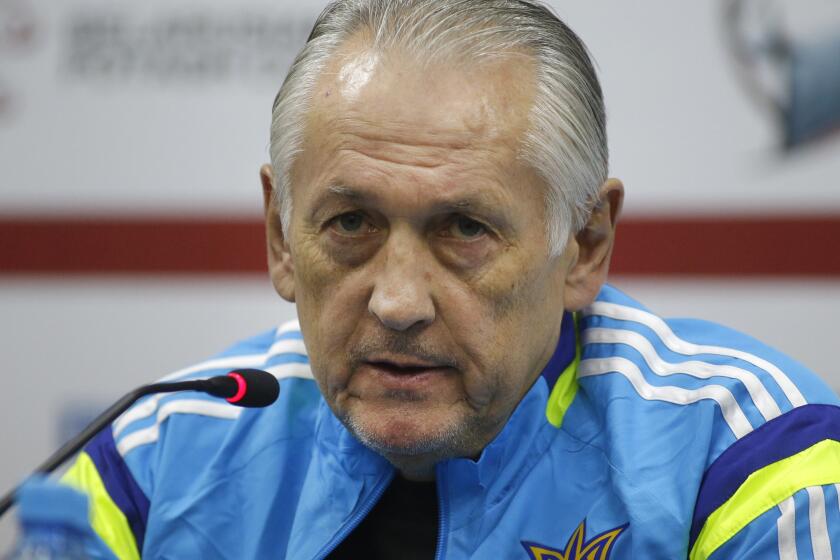 FILE - Ukraine's national soccer team head coach Mykhailo Fomenko speaks during a news conference in Minsk, Belarus, Wednesday, Oct. 8, 2014. Ukraine coach and Soviet-era player for the Dynamo Kyiv Mykhailo Fomenko has died, the Ukrainian club said on Monday, April 29, 2024. He was 75. (AP Photo/Sergei Grits, File)