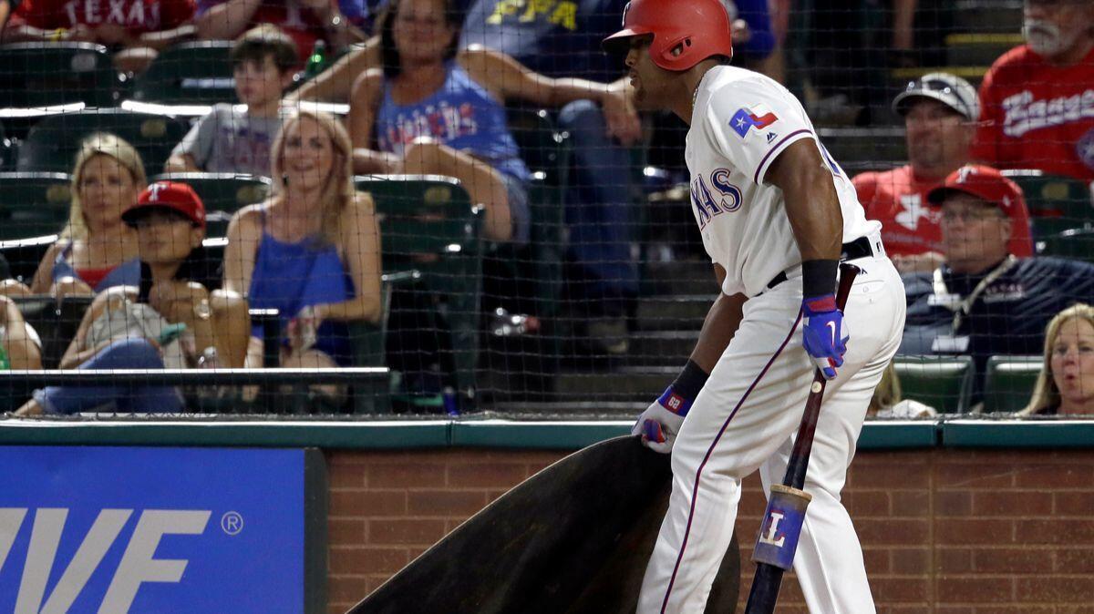 Texas Rangers' Adrian Beltre drags the on-deck circle toward him after being told by the umpire to get closer to it while preparing to bat in the eighth inning Wednesday.