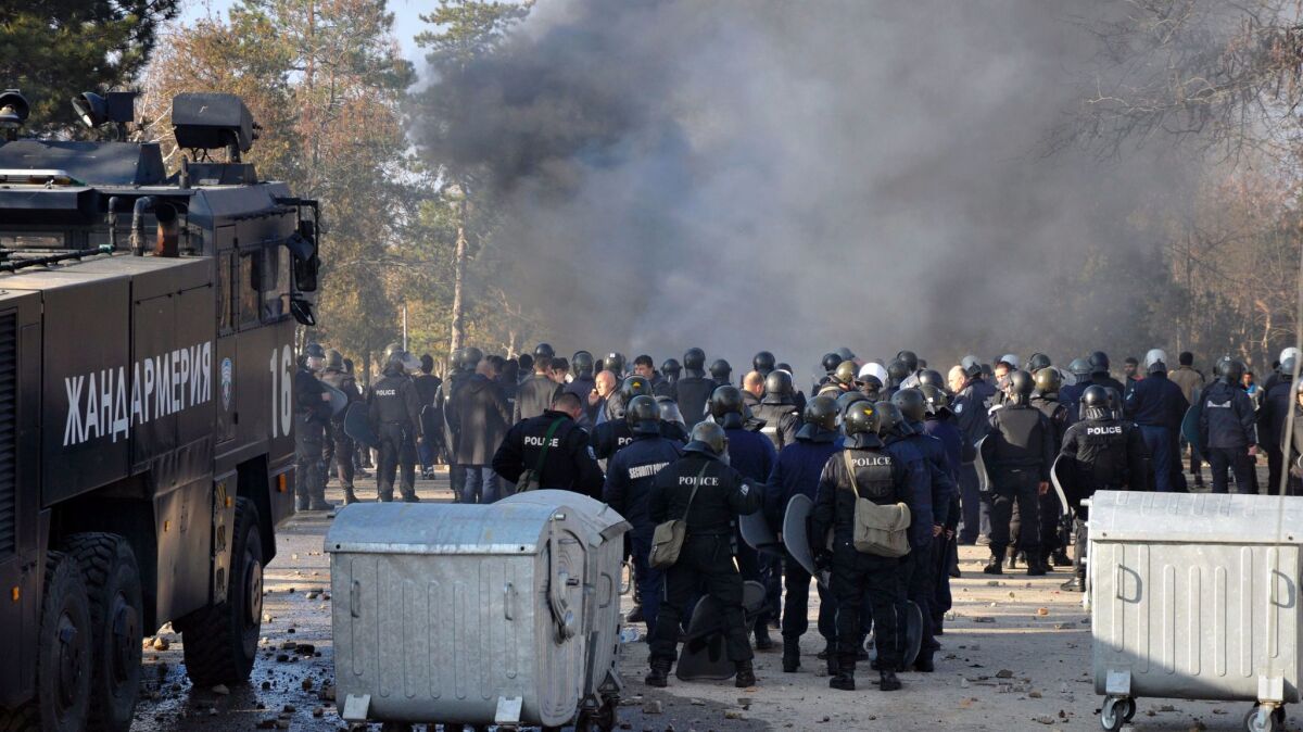 Bulgarian riot police stand ready during clashes Nov. 24 in a camp for migrants in the town of Harmanli.