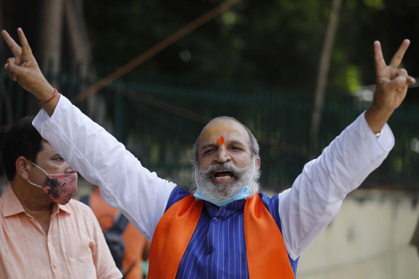 Jai Bhagwan Goyal, a leader of India's ruling Bharatiya Janata Party and an accused in the 1992 attack and demolition of a 16th century mosque, celebrates outside a court in Lucknow, India, Wednesday, Sept. 30, 2020. An Indian court on Wednesday acquitted all 32 accused, including senior leaders of the ruling Hindu nationalist Bharatiya Janata Party, in the case. The demolition sparked Hindu-Muslim violence that left some 2,000 people dead. (AP Photo/Rajesh Kumar Singh)