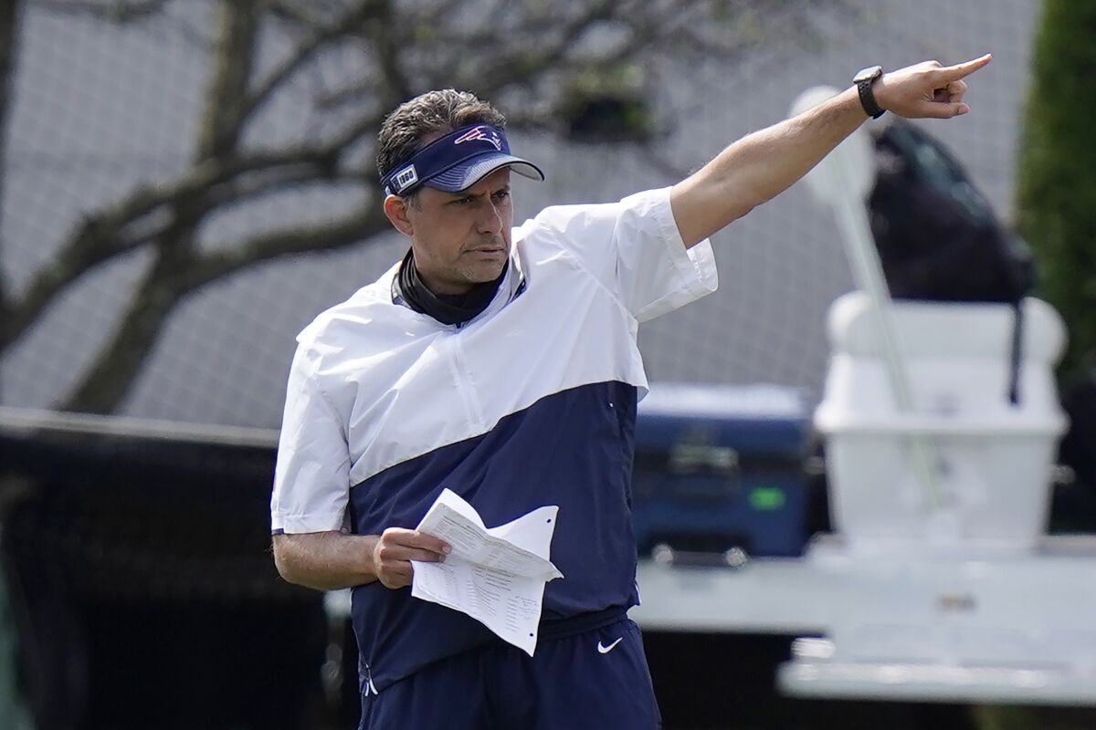 New England Patriots quarterback coach Jedd Fisch coaches players during training camp.