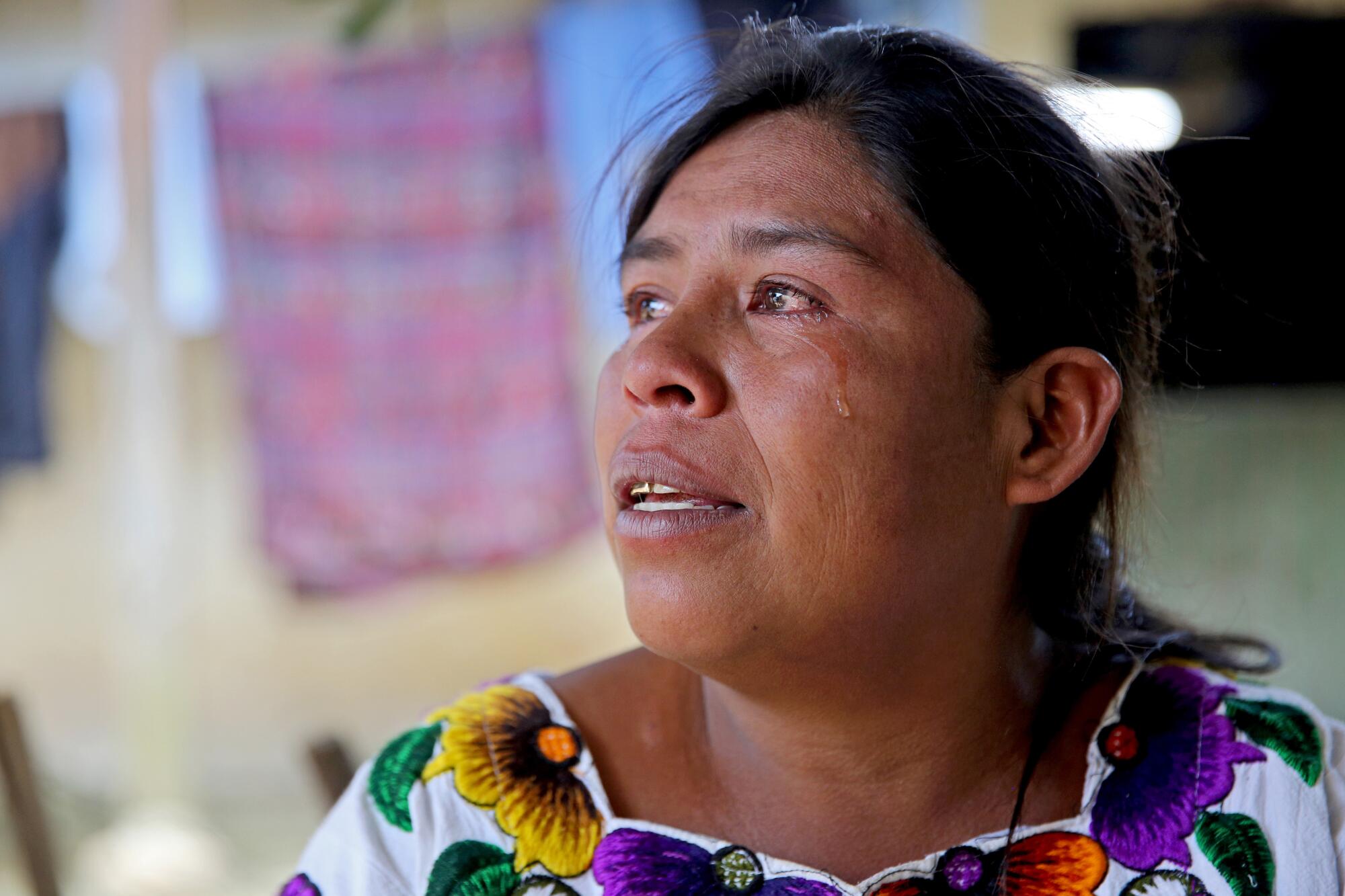 Filomena Crisostomo Miranda, 44 of Caserio Loma Linda, sheds tears as she remembers Blanca Elizabeth Ramirez Crisostomo