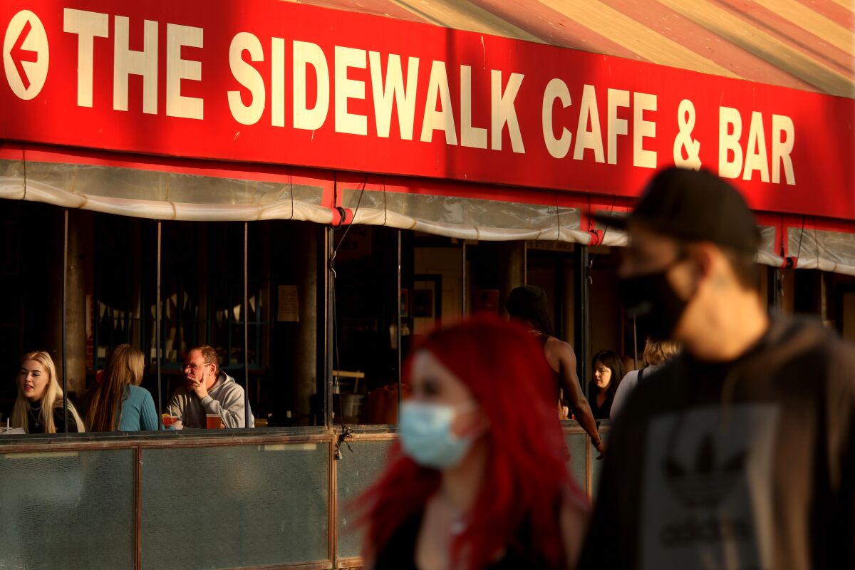 People enjoy a meal at the Sidewalk Cafe & Bar along Ocean Front Walk in Venice 