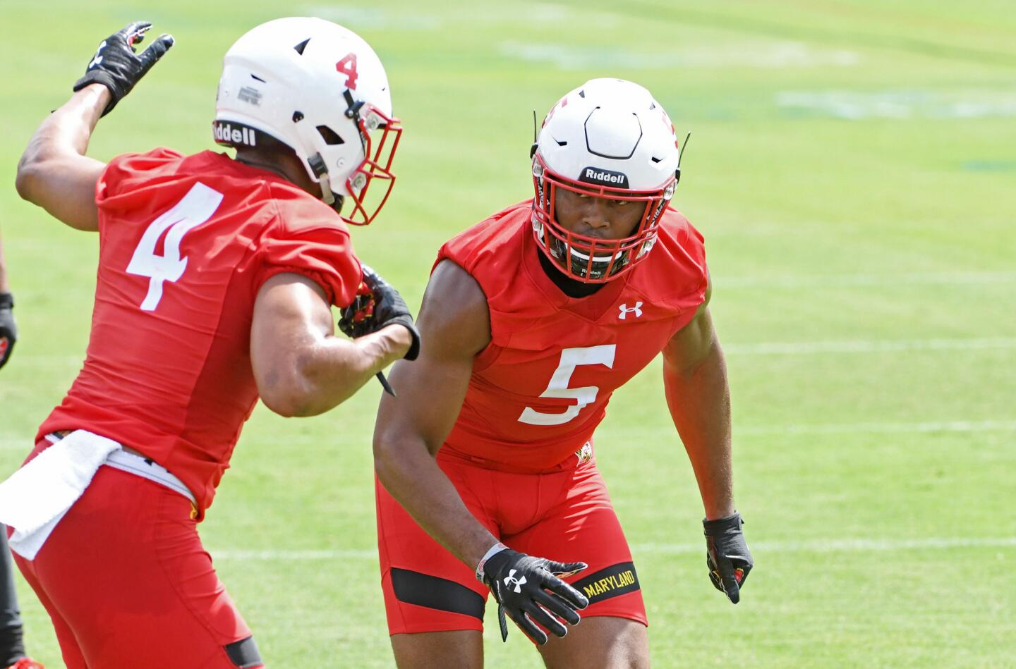 From left, Keandre Jones and Shaq Smith, University of Maryland LBs, face each other during a drill at the Terps training camp on media day.