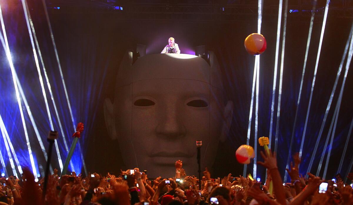 Avicii plays music from atop a giant head at 2012's Coachella Valley Music and Arts Festival.