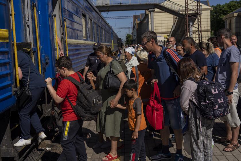 Evacuees board a train in Pokrovsk, Ukraine, on Friday.