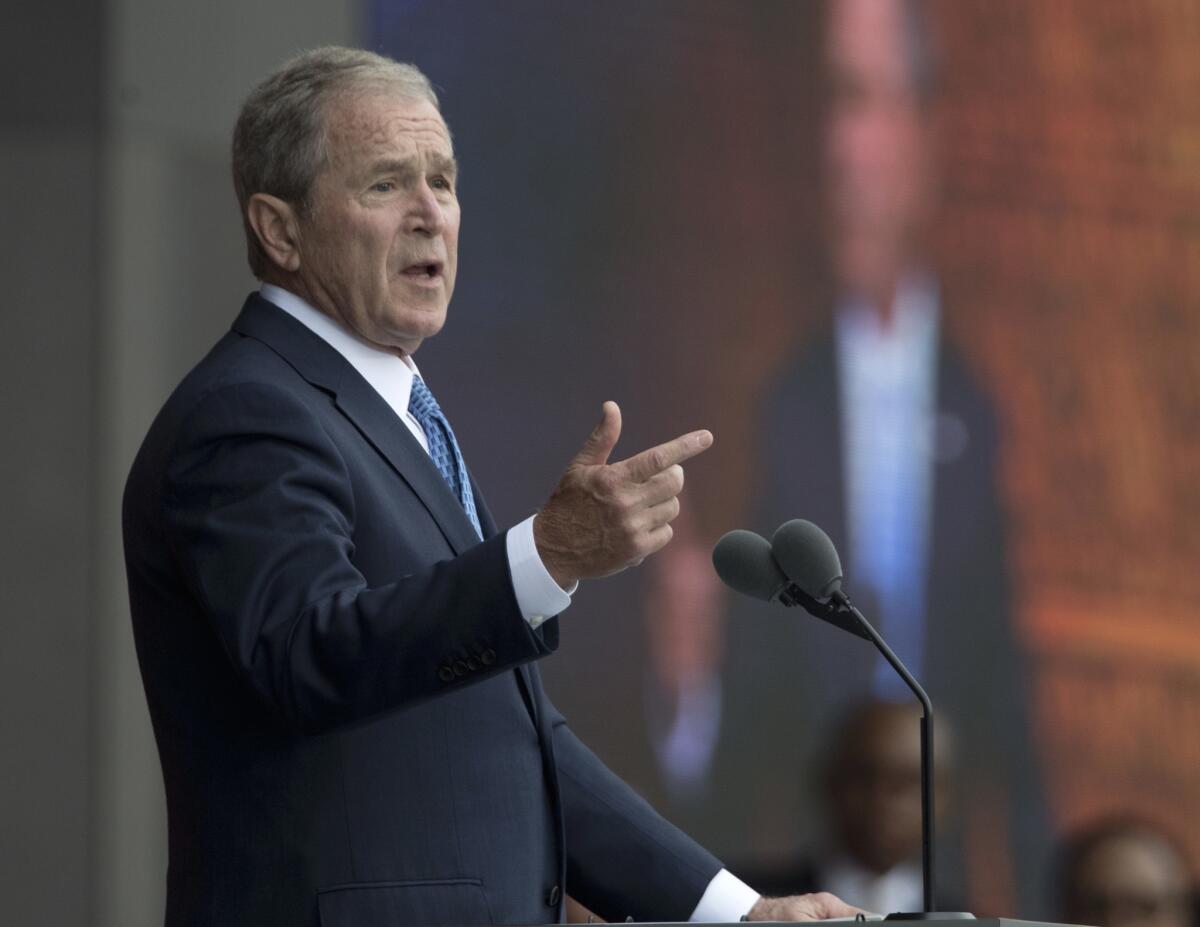 Former President George W. Bush, shown last year, has defended the news media's role in holding world leaders accountable. “It's important for the media to call to account people who abuse their power, whether it be here or elsewhere.”