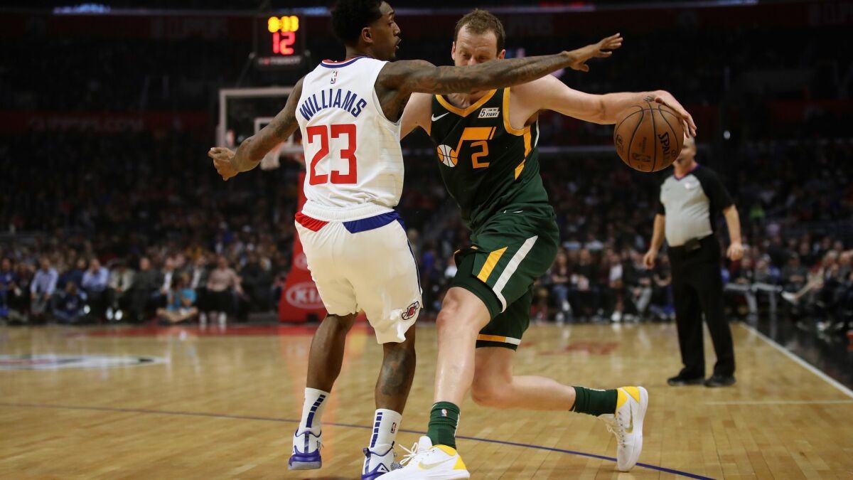 Clippers' Lou Williams (23) defends against the dribble of Utah Jazz's Joe Ingles (2) during the first half at Staples Center on Wednesday.
