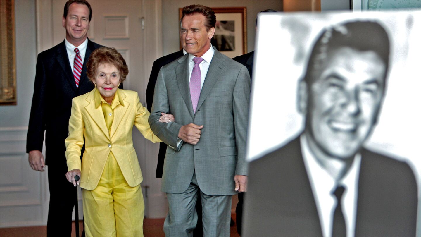 Nancy Reagan is joined by California Gov. Arnold Schwarzenegger and Assemblyman Martin Garrick (R-Carlsbad), left, at a signing ceremony for two bills honoring her late husband at the Reagan library in Simi Valley.