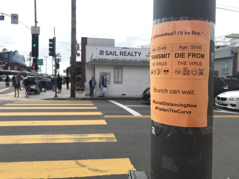 Coronavirus warning sign on pole at Washington Boulevard and Pacific Avenue in Venice. S