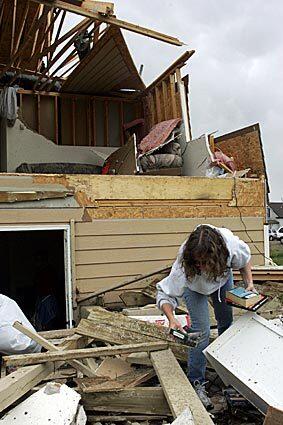 Julie Martinez rummages through the remnants of her Windsor, Colo., apartment after a tornado plowed through. Windsor, a farm town of about 16,000, appeared hardest-hit in Colorado's extreme weather Thursday.