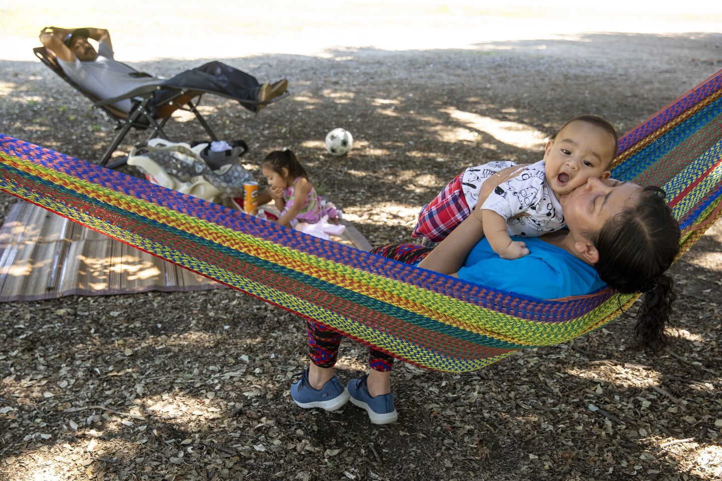 A mother and son play in a hammock at Woodley Park in Van Nuys.