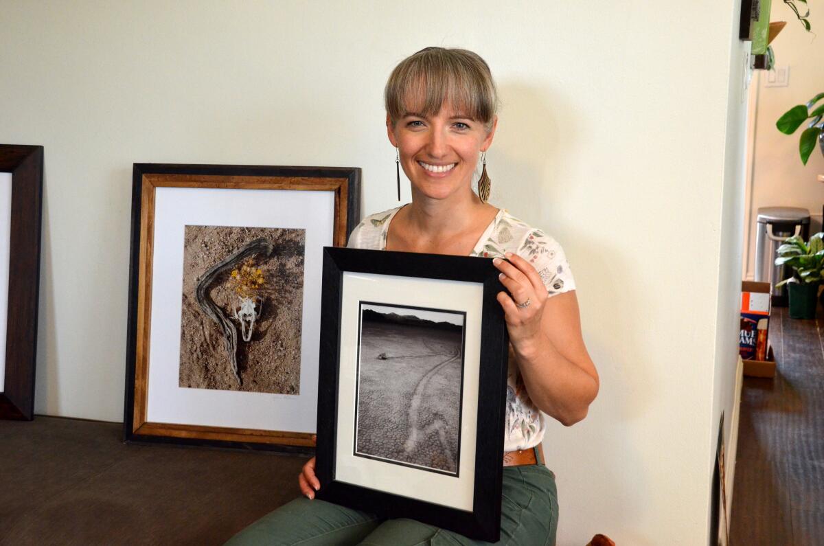 Julia LaPalme of Costa Mesa shows two of her submitted photos for Saturday's Art in the Park show in Newport Beach. The black and white was shot at Death Valley National Park, the other in the Mojave Desert.
