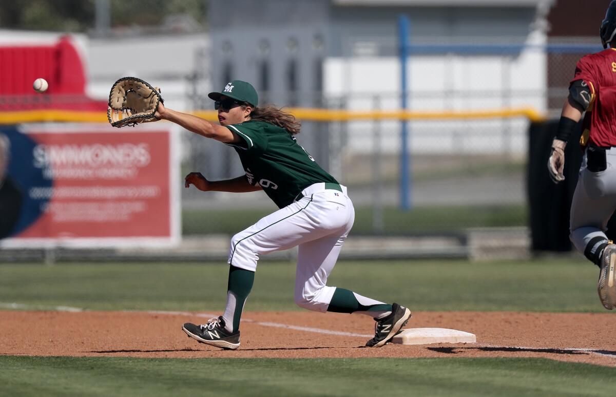Costa Mesa's Vaughn Eberly secures a toss to first base for an out against Estancia during the third inning.