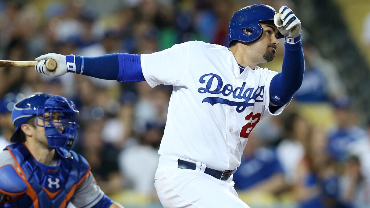 Dodgers first baseman Adrian Gonzalez hits a sacrifice fly in the seventh inning of the Dodgers' 7-4 victory over the New York Mets on Saturday.