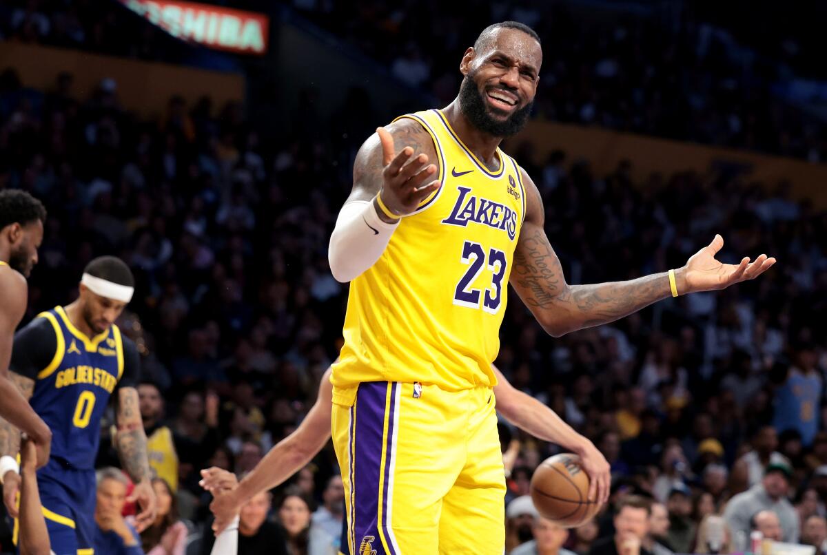 The Lakers' LeBron James raises his arms and disputes a call during a loss to the Warriors Tuesday