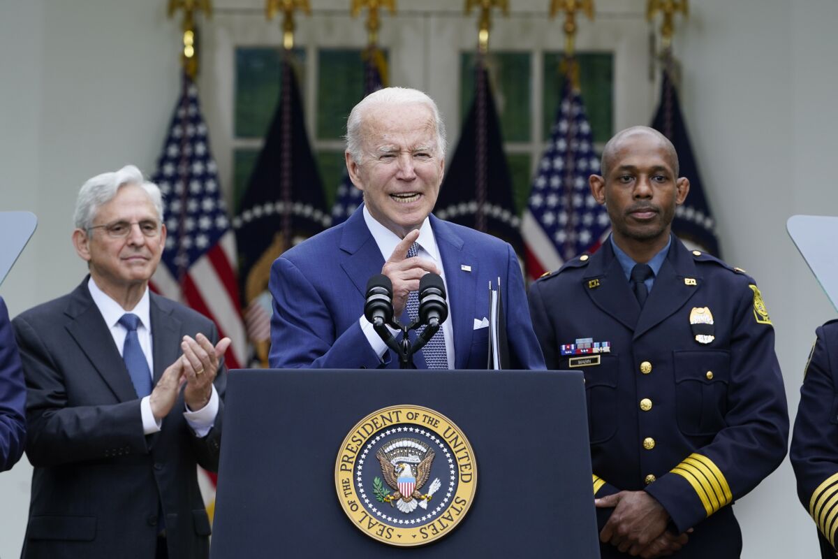 President Joe Biden calls on reporters for questions after speaking in the Rose Garden of the White House in Washington, Friday, May 13, 2022, during an event to highlight state and local leaders who are investing American Rescue Plan funding. Attorney General Merrick Garland, left, and Kansas City, Mo., Police Department Police Chief Joe Mabin listen. (AP Photo/Susan Walsh)