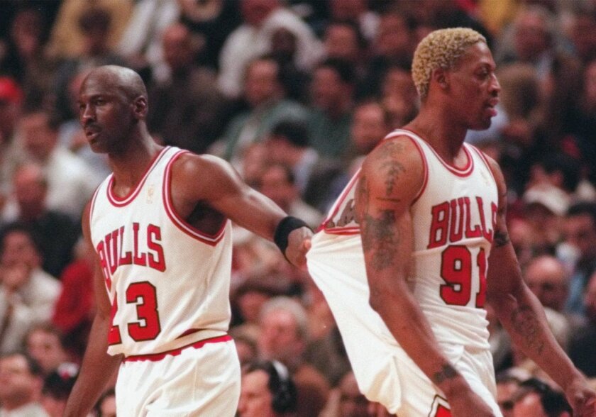 Chicago Bulls star Michael Jordan tries to pull back teammate Dennis Rodman after Rodman receives a technical foul during Game 1 of the 1997 Eastern Conference finals again the Miami Heat.