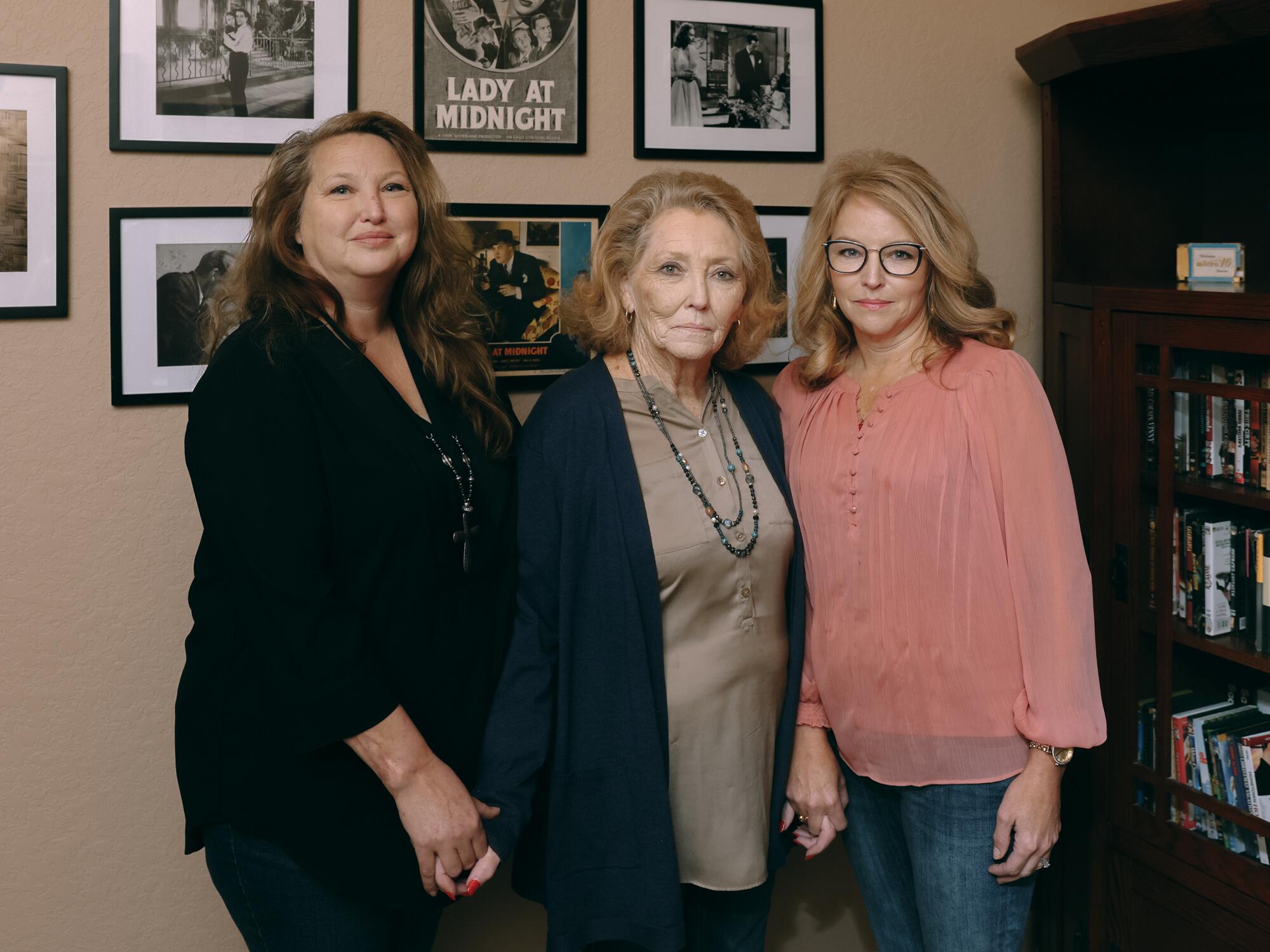 Three women stand side by side.