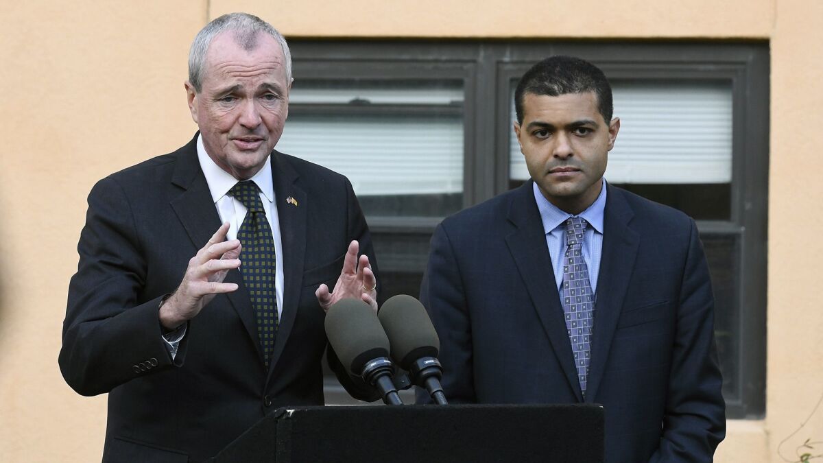 New Jersey Gov. Phil Murphy, left, speaks about a viral outbreak during a news conference with state Health Commissioner Dr. Shereef Elnahal.