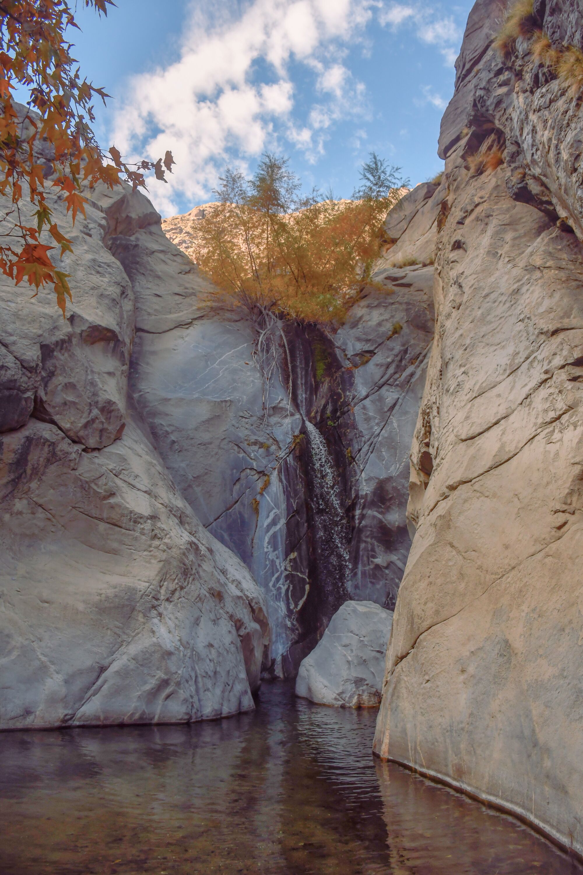 A vertical image of a waterfall amid rocks