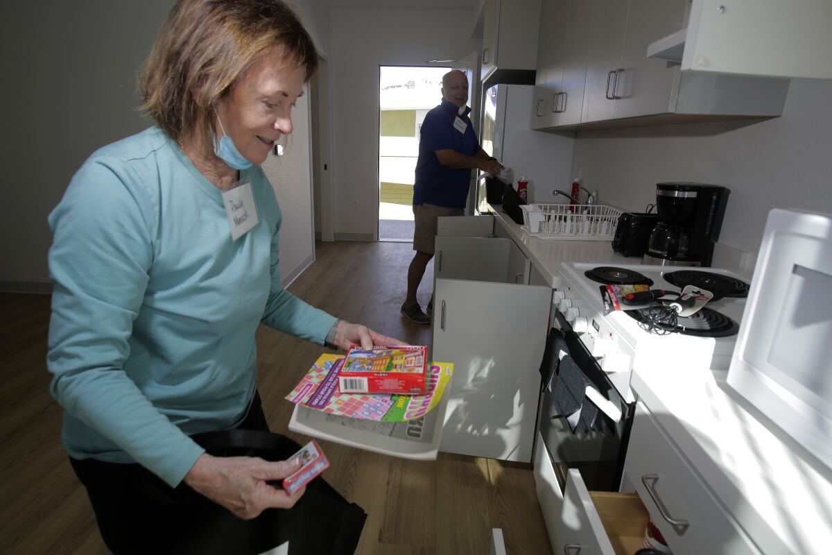 a woman puts games in a drawer
