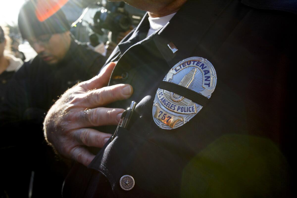 An LAPD badge draped in a black sash.