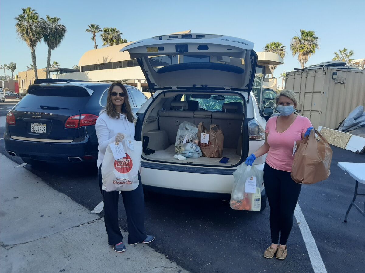 A couple of Stay Home SD’s drivers pack their load of deliveries for the day.
