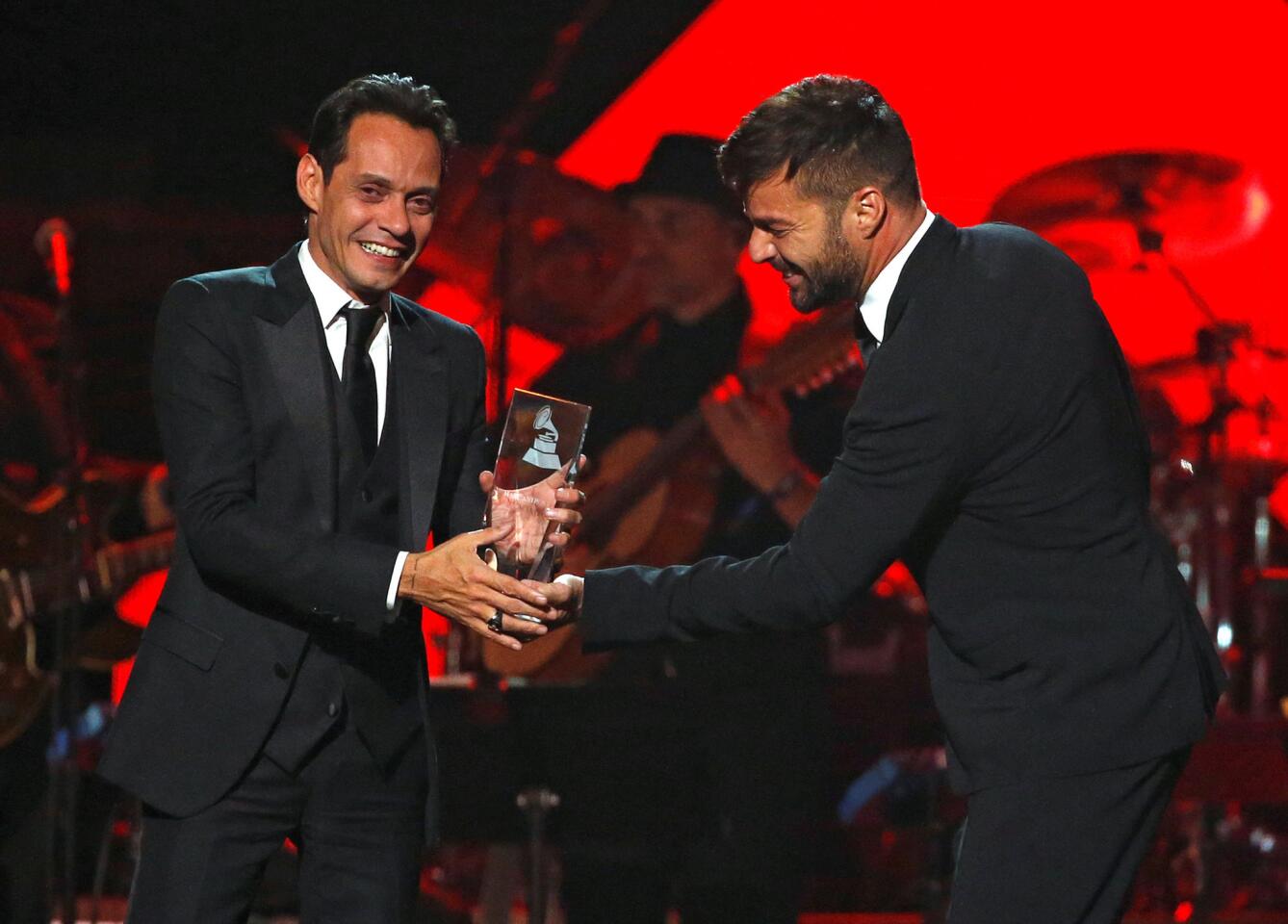 Singer Martin presents recording artist Anthony with the Latin Recording Academy Person of the Year award in Las Vegas