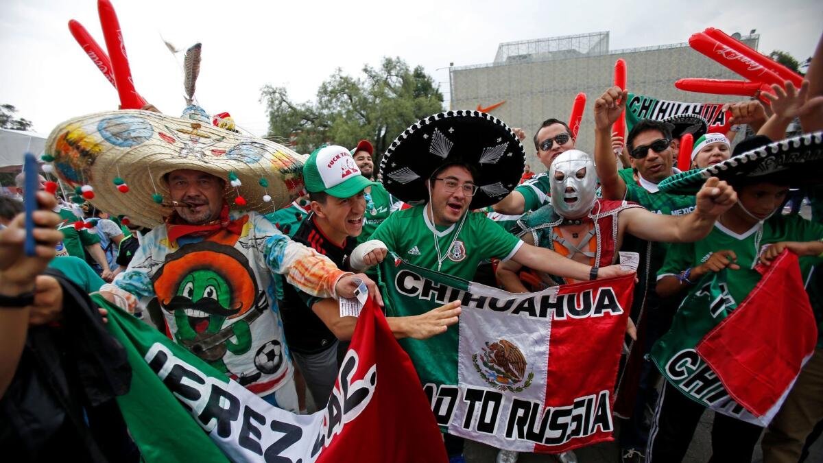 Mexico's fans cheer as they arrive for a World Cup soccer qualifying match between Mexico and the United States at Azteca Stadium in Mexico City.