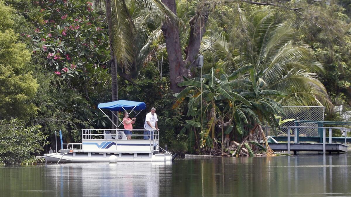 People ride a pontoon boat in Florida. American builders of recreational boats are getting caught up in President Trump’s trade war.