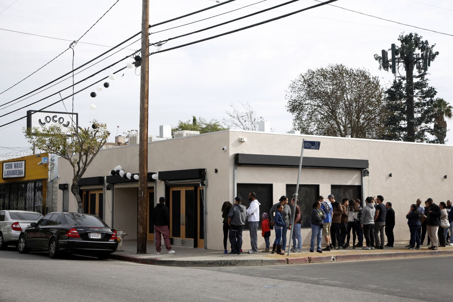 A line of patrons of LocoL wraps around the fast-food project in Watts.
