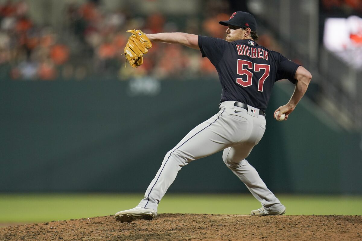 Cleveland Guardians starting pitcher Shane Bieber throws a pitch to the Baltimore Orioles during the sixth inning of a baseball game, Friday, June 3, 2022, in Baltimore. (AP Photo/Julio Cortez)
