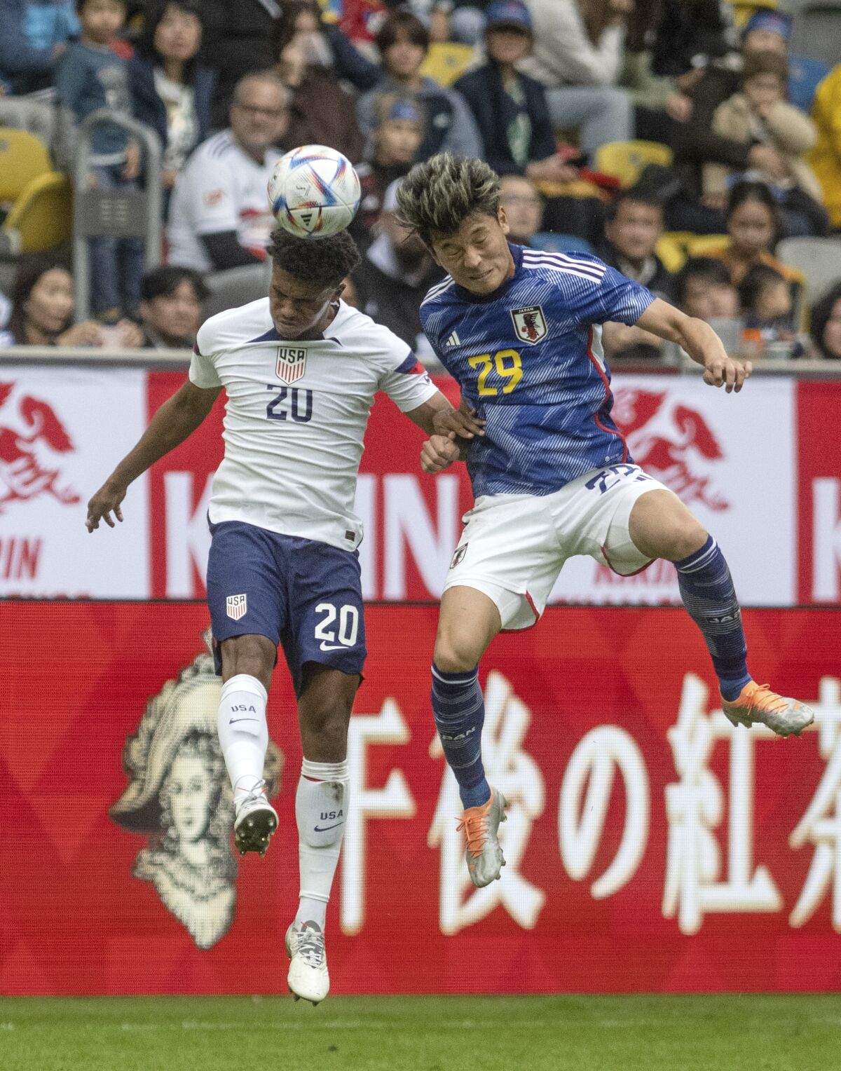 Japan's Machino Shuto, right, and Reggie Cannon from the USA try to get the ball during the international friendly soccer match between USA and Japan as part of the Kirin Challenge Cup in Duesseldorf, Germany, Friday, Sept. 23, 2022. (Bernd Thissen/dpa via AP)