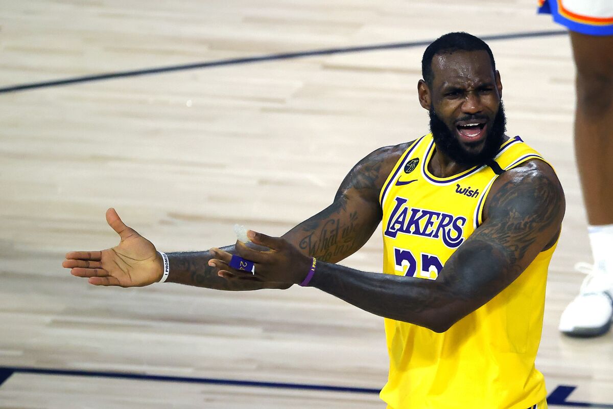 LeBron James of the Los Angeles Lakers reacts to a call against the Oklahoma City Thunder during the second half of an NBA basketball game Wednesday, Aug. 5, 2020, in Lake Buena Vista, Fla. (Kevin C. Cox/Pool Photo via AP)