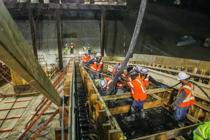 Construction crews pour cement during a nighttime operation at the Gilman Bridge over Interstate 5 in La Jolla, as part of the construction on the Mid-Coast Trolley extension. The roughly 2 billion project is expected to be completed by 2020.