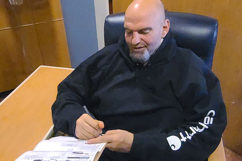 In this photo provided by campaign staffer Bobby Maggio, Pennsylvania Lt. Governor and Democratic Party candidate for a U.S. Senate John Fetterman fills out his emergency absentee ballot for the Pennsylvania primary election in Penn Medicine Lancaster General Hospital in Lancaster, Pa, on Election Day, Tuesday, May, 17, 2022. Fetterman remained in the hospital after suffering a stroke right before the weekend. (Bobby Maggio via AP)