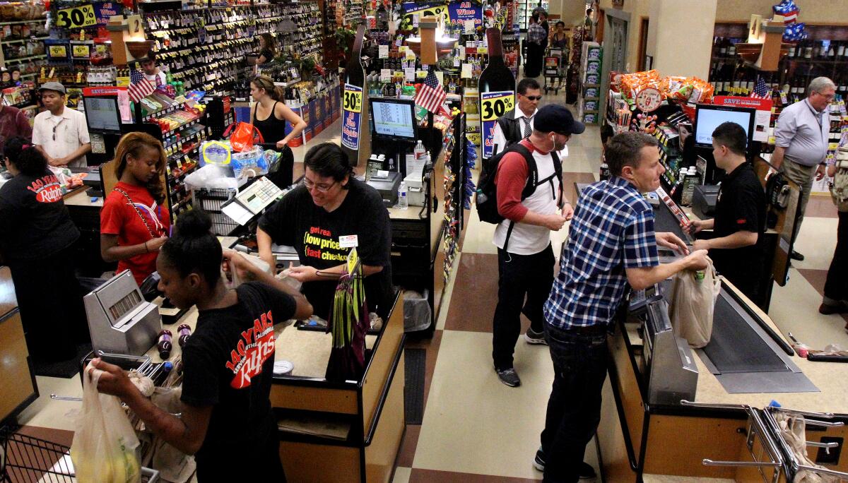 Customers shop at an L.A. grocery store. The L.A. city council voted to pass an ordinance that would require grocery stores to reserve the first hour of business for the elderly and disabled.