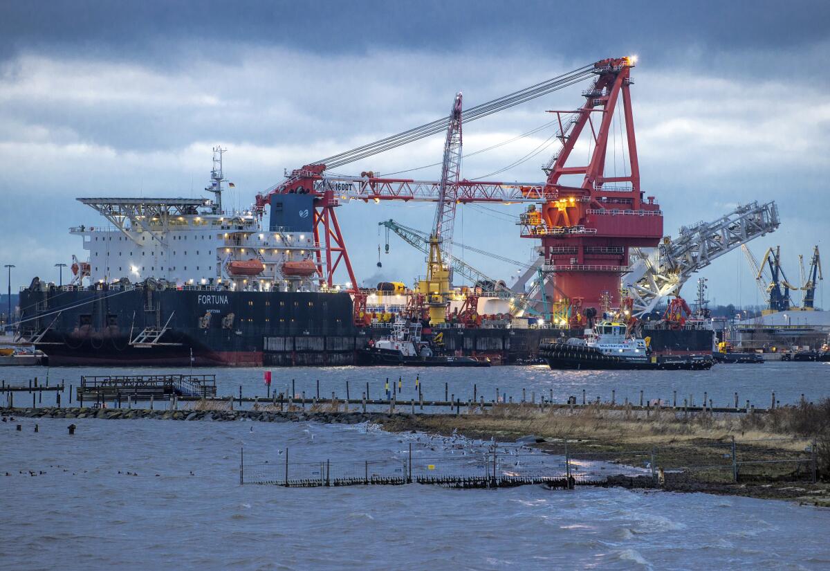 Tugboat next to a pipe-laying ship working on the Nord Stream 2 gas pipeline in the Baltic Sea