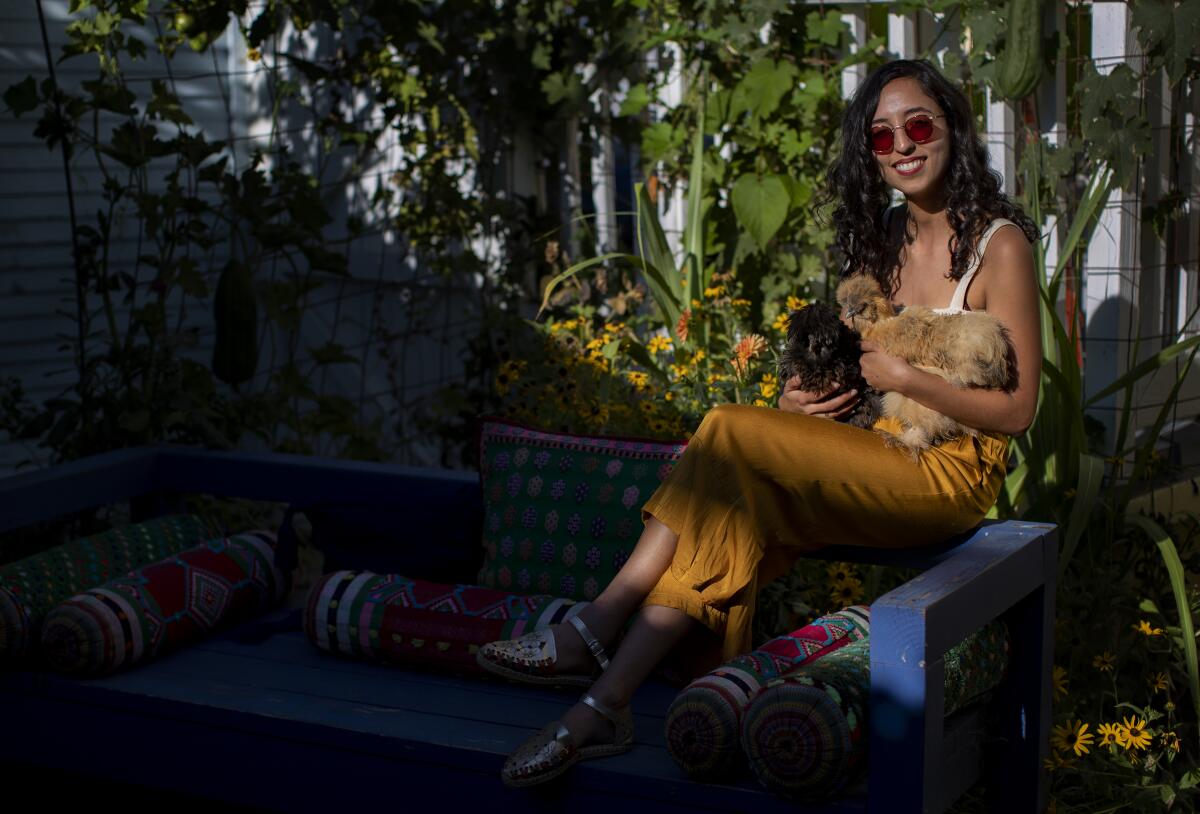 Teapot LA founder Sorina Vaziri holds her affectionate Silkie chickens in her backyard garden.