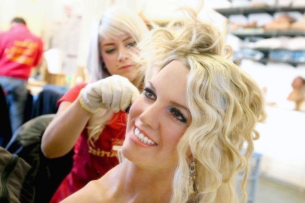 Britney Spears' wax figure has her hair curled by stylist Colleen Sluss in the Studio of Madame Tussauds Hollywood.