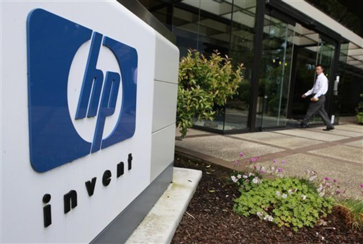 A worker arrives at Hewlett Packard Company headquarters in Palo Alto, Calif., Tuesday, June 1, 2010. HP said it will lay off about 9,000 workers in the unit that provides technology services to other businesses as the company consolidates and automates its commercial data centers. The cuts will be made over about three years and amount to some 3 percent of HP's global work force. (AP Photo/Paul Sakuma)