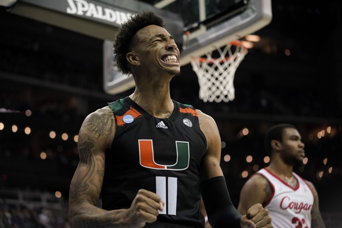 Miami guard Jordan Miller celebrates after scoring against Houston in the second half of a Sweet 16 college basketball game in the Midwest Regional of the NCAA Tournament Friday, March 24, 2023, in Kansas City, Mo. (AP Photo/Charlie Riedel)