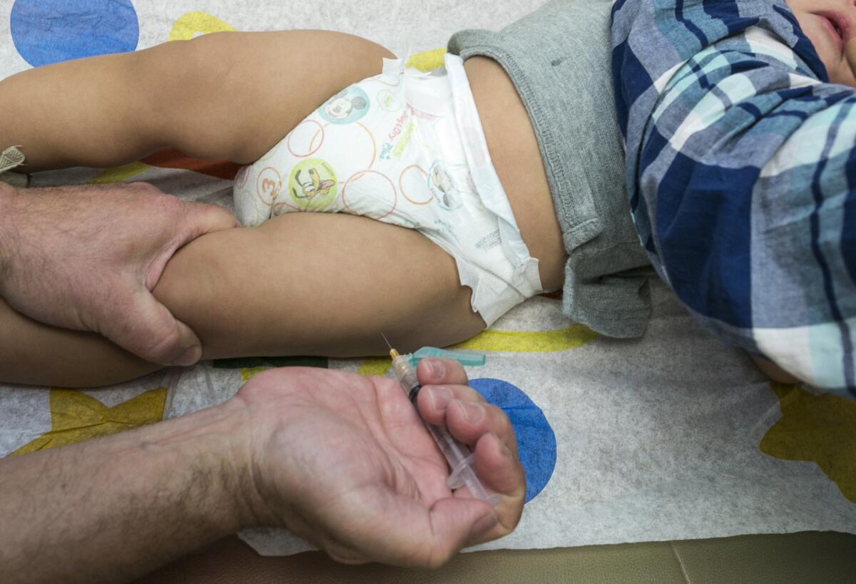A 1-year-old is injected with the MMR vaccine, which protects against measles, in January in Northridge.