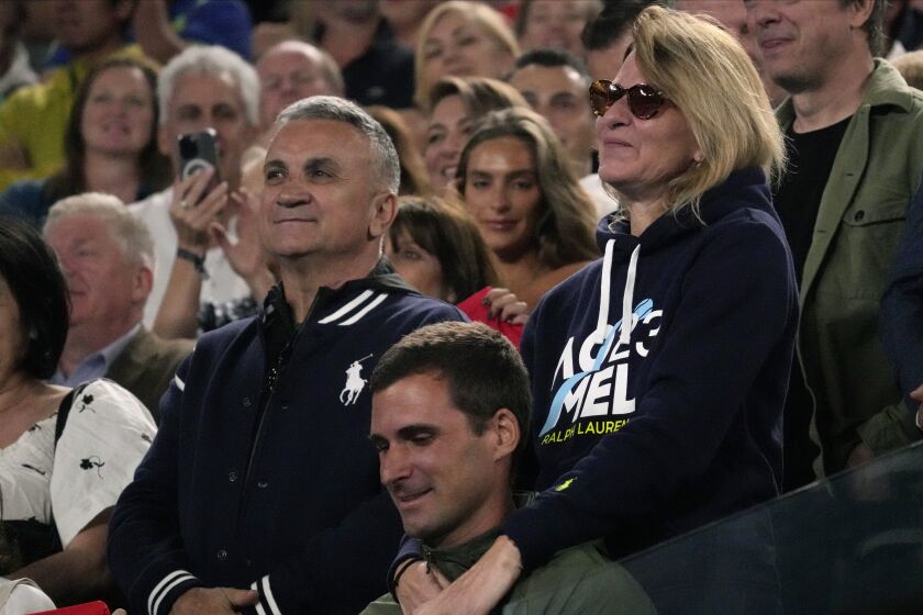 The parents of Novak Djokovic of Serbia, father Srdjan and mother Dijana react during his post match speech following his win over Andrey Rublev of Russia at the Australian Open tennis championship in Melbourne, Australia, Wednesday, Jan. 25, 2023. (AP Photo/Dita Alangkara)